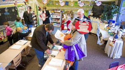 Parents and prospective students visit first-grade teacher Bonnie Kietz's classroom at Holy Child Catholic School's open house and science fair Sunday.