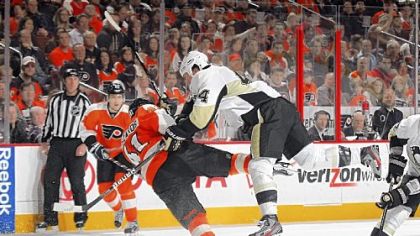 Brooks Orpik knocks Philadelphia's Andrej Meszaros off his skates Saturday.