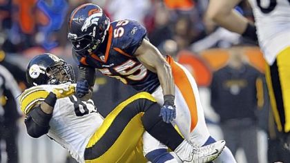 The Broncos' D.J. Williams takes down David Johnson Sunday in the third quarter.