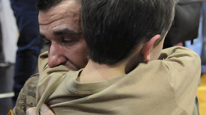 Sgt. Fredrich Ramien of Trafford hugs his son Jacob, 7, Saturday in New Kensington after a year in Afghanistan with the 307th Military Police Company.