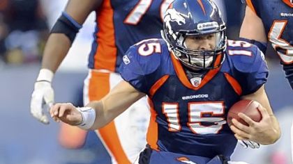 Broncos quarterback Tim Tebow gets by Steelers linebacker James Harrison Sunday in the third quarter at Sports Authority Field at Mile High in Denver.