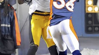 Jerricho Cotchery pulls in a pass for a touchdown Sunday against the Broncos' Rafael Bush in the fourth quarter at Sports Authority Field at Mile High in Denver Sunday.