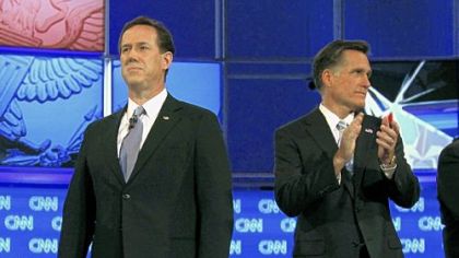 Republican rivals Rick Santorum, left, and Mitt Romney await the start of Wednesday's debate in Mesa, Ariz.