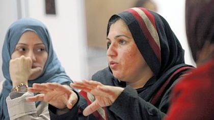 International Women of Courage honorees Samar Badawi, left, a political activist from Saudi Arabia, and Shad Begum, a human rights activist from Pakistan, talk at a discussion and reception Monday at Gwen's Girls in Point Breeze.