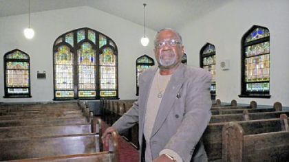 The Rev. Algie Robinson Jr. stands inside Christian Fellowship Baptist Church on Perrysville Avenue on the North Side.
