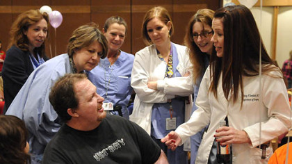 Jenny Ziembicki, right, medical director of the UPMC Mercy Burn Center, joins medical staff to greet former burn patient Bob Namola at the 18th annual Burn Survivor Sunday. Mr. Namola lost both legs in a 2010 motorcycle accident that put him in UPMC Mercy's burn unit for more than a year.