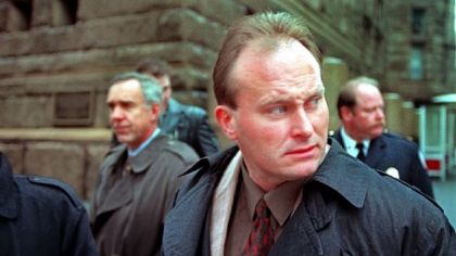 November 1996: Brentwood police Officer John Vojtas looks away from protesters in front of the Allegheny County Courthouse, as he and his legal team cross Grant Street during a recess in now-Sgt. Vojtas' trial.