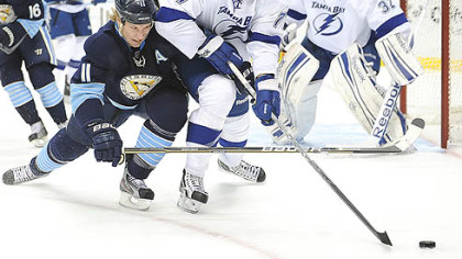Penguins' Jordan Staal battles for the puck against Tampa Bay Lightnings' Victor Hedman at the Consol Energy Center.