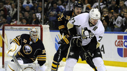 Sabres' Ryan Miller watches teammate Paul Gaustad battle for the puck with Evgeni Malkin during the second period in Buffalo.