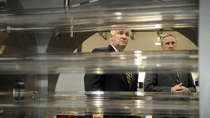 Gov. Tom Corbett, left, and John Stanik, CEO of Calgon Carbon, look at the ultraviolet lamps inside of a UV reactor at the Calgon Carbon UV Technologies plant in Findlay on Friday. The reactor is used to clean water with ultraviolet light.