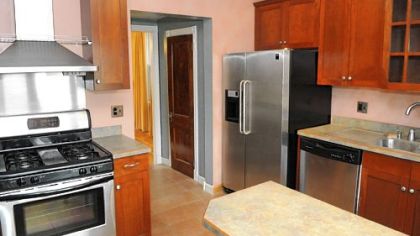 The kitchen has a ceramic tile floor, laminate counter tops and newer stainless-steel appliances.