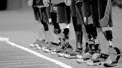 The Wounded Warrior Amputee Softball Team lines up for the national anthem before an exhibition game.
in Plant City, Fla.
