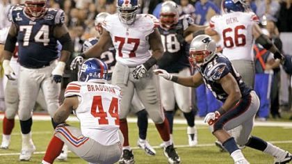 New York Giants running back Ahmad Bradshaw (44) rushes for a touchdown in front of New England Patriots linebacker Jerod Mayo (51) during the second half of the NFL Super Bowl XLVI football game