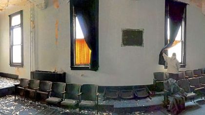 Paint chips cover the carpet in a second-floor meeting room Friday at the Masonic Lodge on Pittsburgh's Central Northside. Developers plan to convert this space into apartments. The structure was built in 1895.