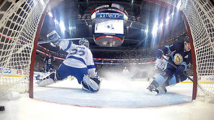 Evgeni Malkin scores against Lightning goalie Mathieu Garon in the second period Sunday night at Consol Energy Center. The Penguins won, 4-2, behind Malkin's two goals.