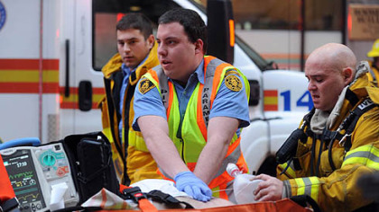 Paramedics perform CPR on a man who was found inside the Roosevelt Arms building on Penn Avenue in Downtown Pittsburgh after a fire broke out on the 9th floor of the building on Thursday,