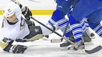 Craig Adams battles for a loose puck against the Toronto Maple Leafs early in Tuesday night's come-from-behind victory against the Maple Leafs at Consol Energy Center - the Penguins' eighth win in a row.