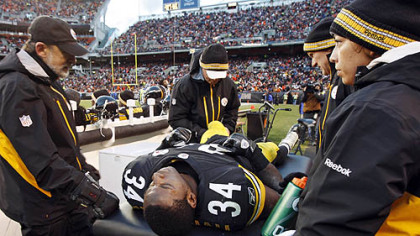 Rashard Mendenhall is examined on the sideline after an injury in the first half of the game against the Cleveland Browns.