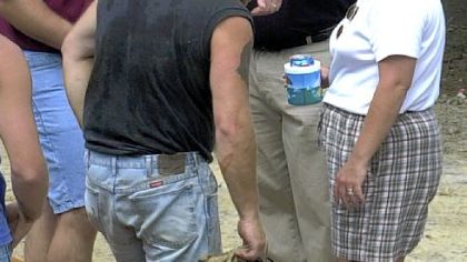 A rescued coal miner and his wife listen to Larry Winckler, top right, of Falcon Drilling in 2002.