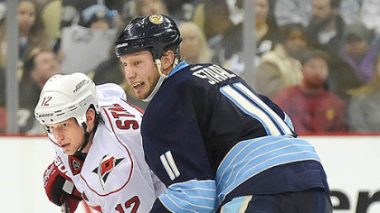 Jordan Staal of the Penguins jostles for position with his brother, Eric, of the Carolina Hurricanes during a game in December.
