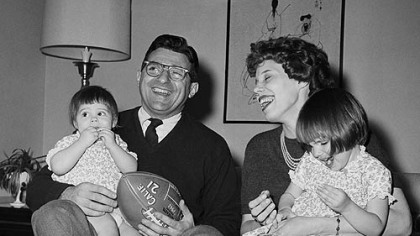 In this Feb. 16, 1966 file photo, new Penn State head football coach Joe Paterno poses with his one-year-old daughter Mary Kathryn on his lap and his wife Suzanne, with two-year-old daughter Diana Lynne, at their home in University Park, Pa.