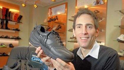 Evan Schwartz, president of Aetrex, a Teaneck, N.J.-based shoe manufacturer, shows off a shoe fitted with a GPS device that can monitor a wearer.