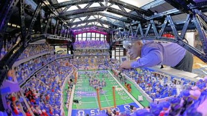 Builder Brian Alano adjusts a piece in his Lego scaled replica of Lucas Oil Stadium which is on display at the Super Bowl XLVI media center in Indianapolis.  Alano spent three years and used over 30,000 pieces to build the model of the site where New England and New York will contest Super Bowl XLVI Sunday.