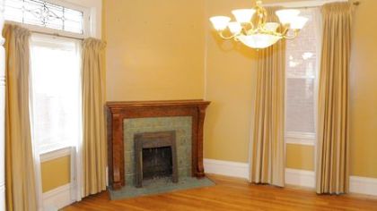 The dining room has built-in cabinets and a fireplace converted to burn gas.