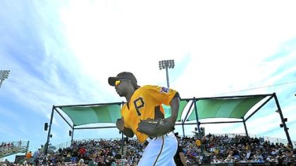 Andrew McCutchen runs on to the field for the Pirates home exhibition opener Sunday at McKechnie Field in Bradenton, Fla.