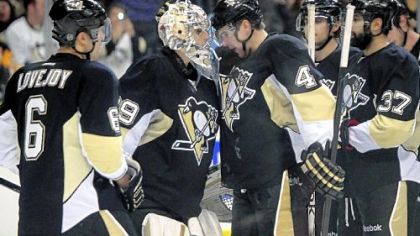 Marc-Andre Fleury celebrates with teammates after holding the Coyotes to one goal in a 2-1 victory.