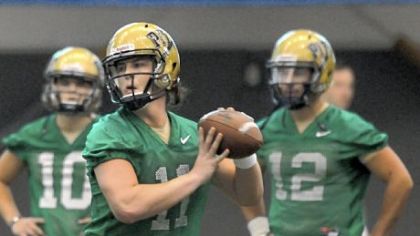 Pitt quarterbacks Trey Anderson (10) and Tino Sunseri (12) watch as Mark Myers works a passing drill Thursday on the first day of spring practice.