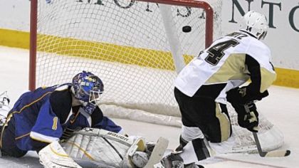Chris Kunitz, right, flips the winning shootout goal past Blues goalie Brian Elliott Tuesday night in St. Louis. The 3-2 victory extended the Penguins' winning streak to seven games going into the All-Star break.