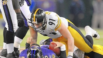 Defensive end Aaron Smith stands over top of Ravens quarterback Joe Flacco after a sack in a Dec. 2008 at M&T Bank Stadium in Baltimore.