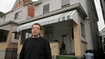 Matthew Heckter stands in front of his family home. He works as a night stocker at Giant Eagle to provide for his wife and daughter, with another baby on the way.