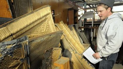 Ben Lloyd of Construction Junction takes a look at tin ceiling panels harvested from buildings scheduled for demolition in the block of Fifth Avenue and Wood Street, Downtown. PNC will build its new tower there.