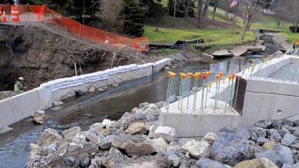 Workers with the Pugliano Construction Co. Inc. work nine feet below the creek bed to lay a footer for a new bridge on Thompson Run Road in Ross.