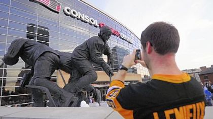 Brian Smith of Canonsburg takes a photo of his hockey idol's statue Wednesday before the Penguins game with Toronto.