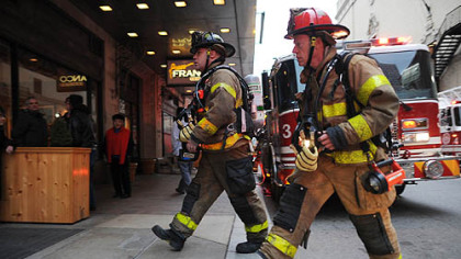 Firefighters respond to a fire on the ninth floor of the Roosevelt Arms building on Penn Avenue in Downtown Pittsburgh.