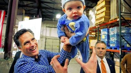 Republican presidential candidate Mitt Romney hands 6-month-old Dexter Hall back to his mother during a campaign stop at Freightmasters, Inc. in Eagan, Minn., on Wednesday.