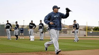 Seattle pitcher Felix Hernandez covers first in a drill for pitchers Tuesday in Peoria, Ariz. The Mariners were the first team to open camp, welcoming pitchers and catchers Sunday.