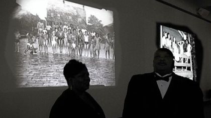 Photographs by Charles "Teenie" Harris are projected onto the wall at Carnegie Museum of Art as part of "Teenie Harris, Photographer: An American Story."