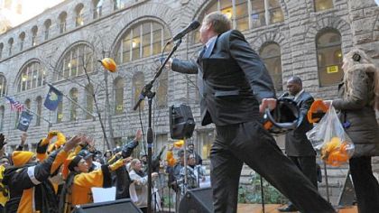 Allegheny County Executive Rich Fitzgerald throws Terrible Towels and other Steelers items to the crowd during the rally Friday at the Allegheny County Courthouse, Downtown.