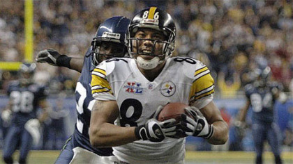 Hines Ward flashes his trademark smile while scoring a touchdown for the Steelers in Super Bowl XL. The score clinched the championship for the Steelers and the game MVP award for Ward.
