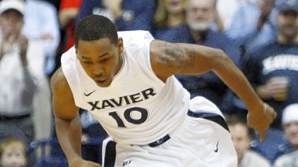 Xavier's Mark Lyons steals the ball from Duquesne's T.J. McConnell in the first half of Wednesday night's Atlantic 10 game in Cincinnati.