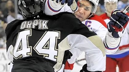Brooks Orpik puts a hit on the Capitals' Alex Ovechkin in the second period of the Penguins' 4-3 overtime win Sunday at Consol Energy Center.
