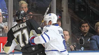 Evgeni Malkin is run into the boards by Toronto's Luke Schenn Wednesday night in the Penguins' 1-0 loss to the Maple Leafs at the Air Canada Centre in Toronto.