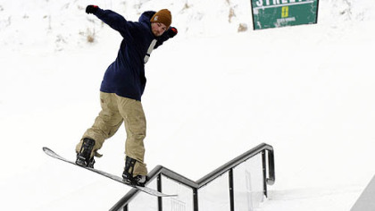 Cam Pierce of Forum Snowboards demonstrates his snowboarding and balancing skills on a rail at the grand opening of The Streets, a terrain park dedicated to urban snowboarding at Seven Springs Mountain Resort.
