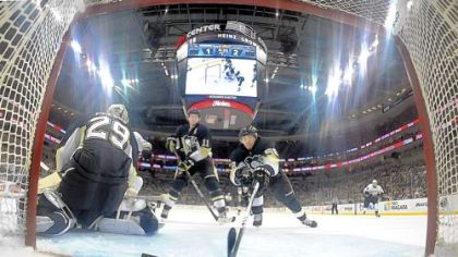 Kris Letang makes a save on the puck just before it crosses the goal line against the Ducks late in the third period Wednesday night.