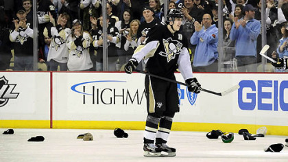 Evgeni Malkin skates through the shower of hats that littered the ice after he scored his third goal Saturday in the Penguins' 8-1 rout of Tampa Bay at Consol Energy Center.