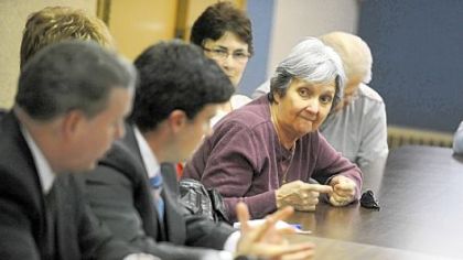 Bloomfield resident Peg Sciullo leans forward to ask a question of city Councilman Bill Peduto, city Controller Michael Lamb and Councilman Corey O'Connor Monday during their announcement of a program to help Pittsburgh residents challenge their 2012 property assessment values at the Immaculate Conception Church in Bloomfield.